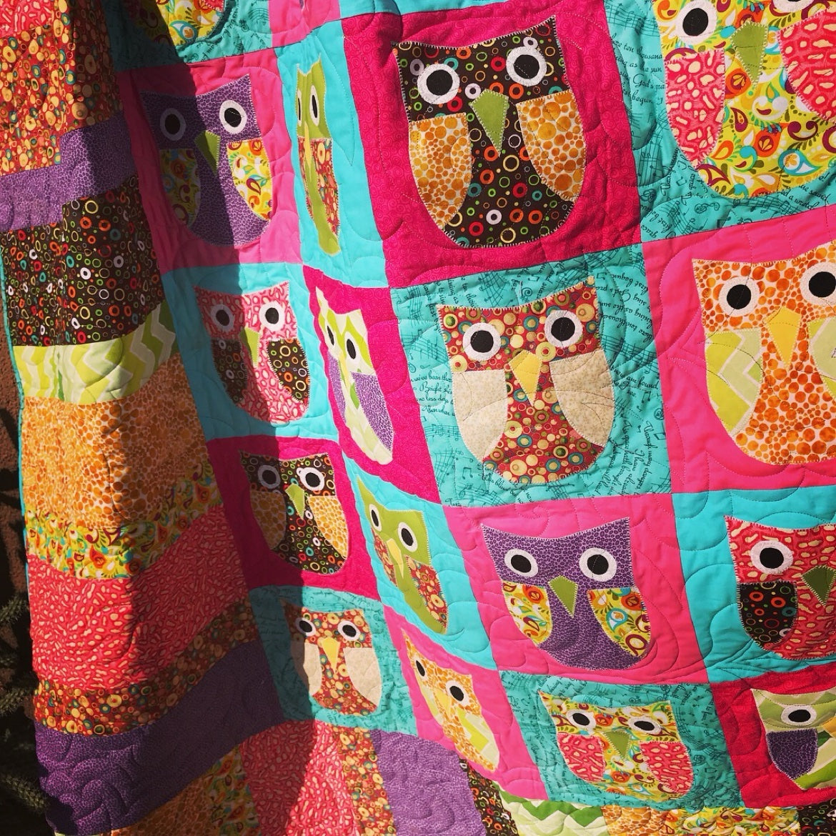 Modern geometric quilt detail with computerized longarm quilting
